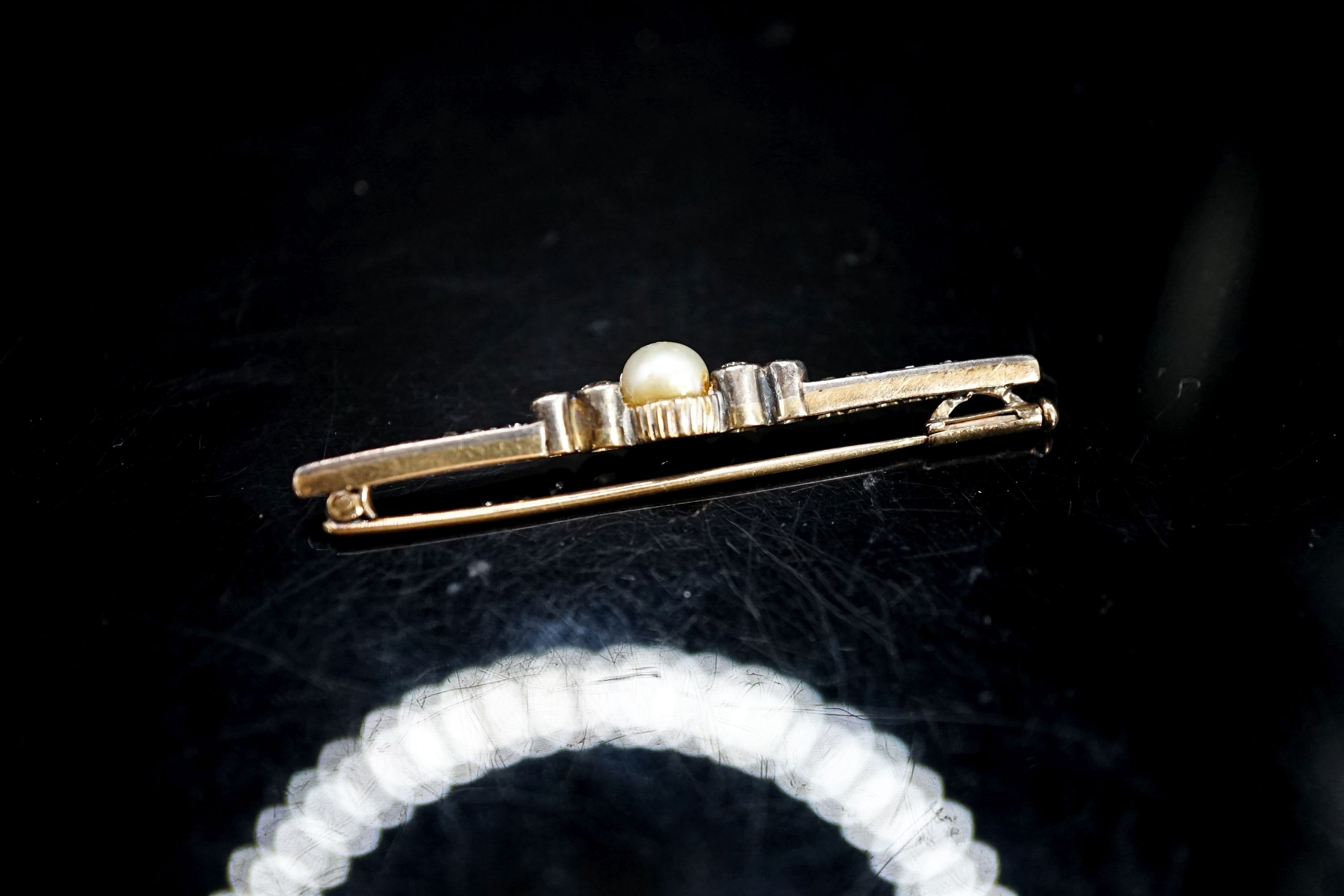 An early 20th century pearl and diamond set bar brooch, 50mm, gross 3.8 grams.